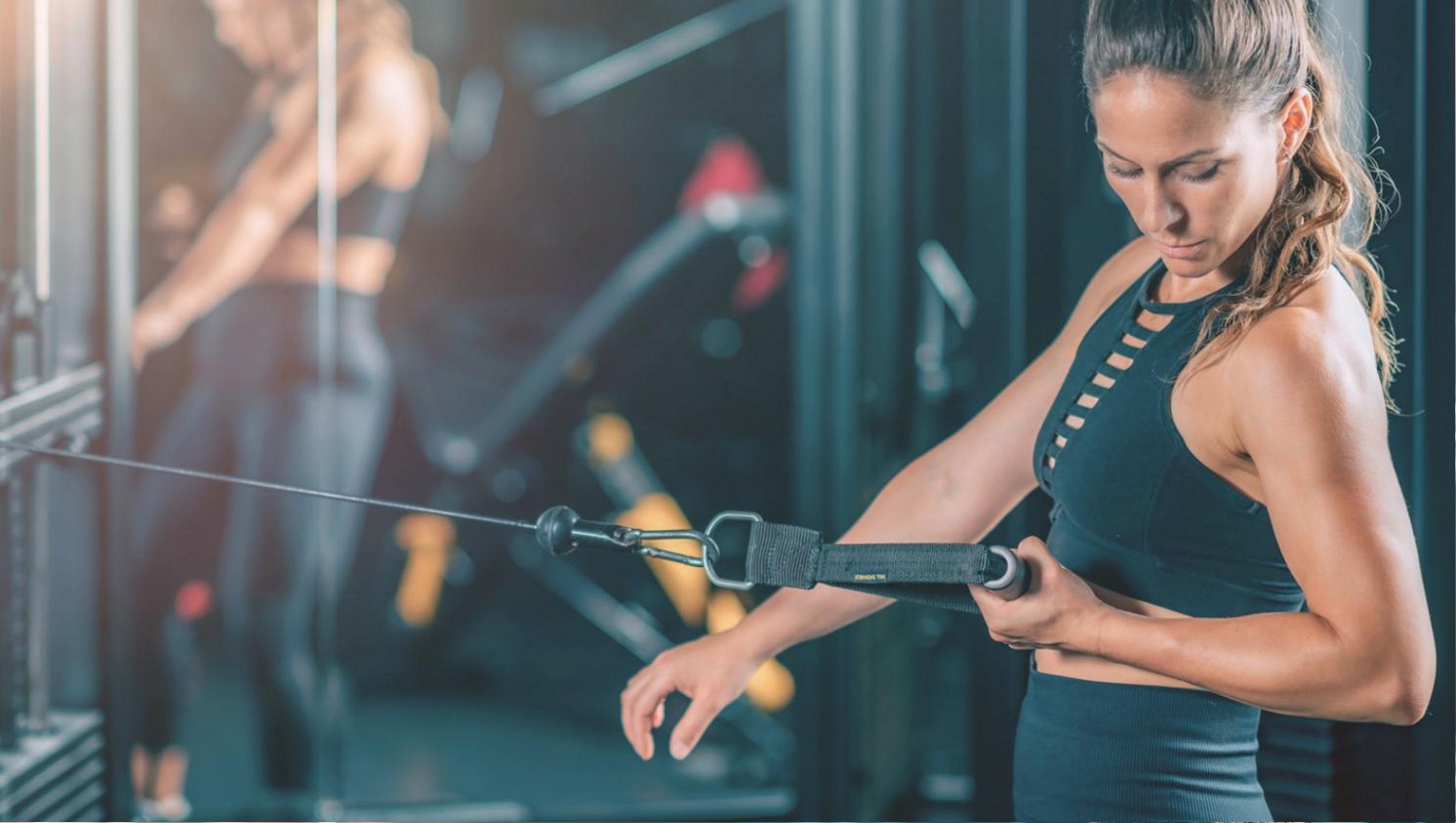 Coach reviewing CrossFit load programming data on a whiteboard with athlete